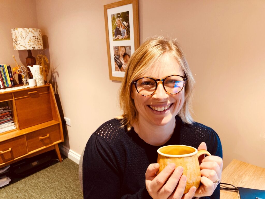 Kelly Hall holding a cup of tea